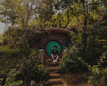 Man standing by tree against plants