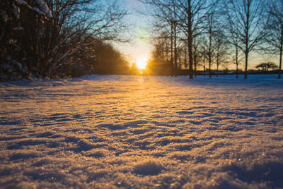 Scenic view of snow covered landscape against sky during sunset