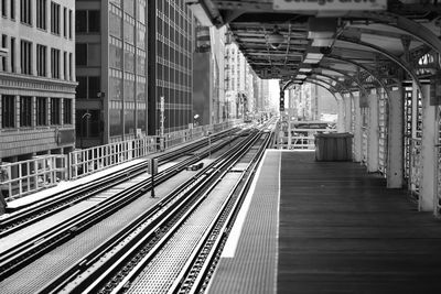 Railroad tracks amidst buildings in city