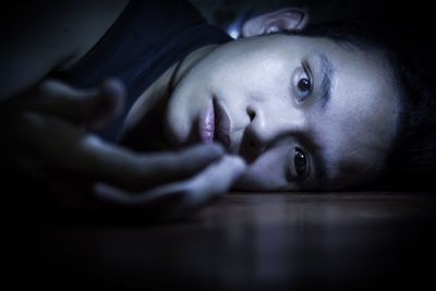 Close-up portrait of a teenage girl in the dark