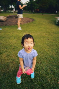 Boy playing on grassy field