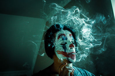 Portrait of young woman smoking cigarette