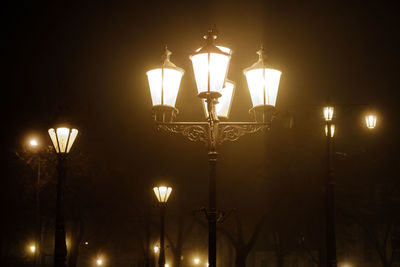 Low angle view of illuminated street light at night