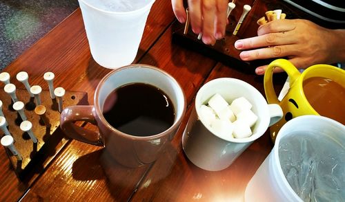 Close-up of hand holding coffee cup