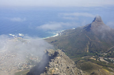 High angle view of sea and mountains against sky