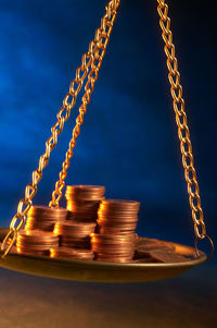 Close-up of illuminated lighting equipment on table against sky at night