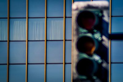 Full frame shot of glass window behind traffic lights