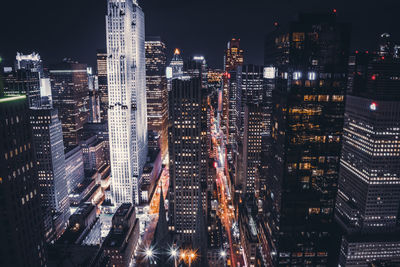 Aerial view of city lit up at night