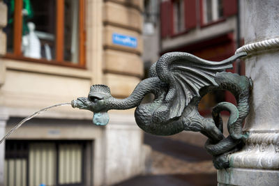 Close-up of statue against building