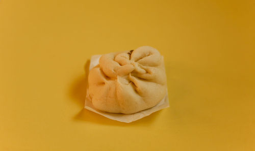 Close-up of statue against yellow background