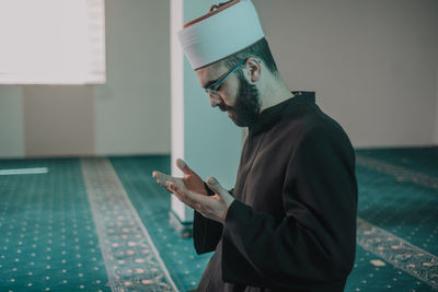 Side view of man in mosque