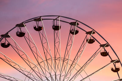 Low angle view of silhouette ferris wheel against sky during sunset