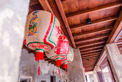 Low angle view of lanterns hanging outside building