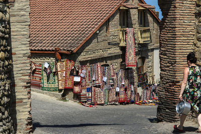 People on street amidst buildings in city