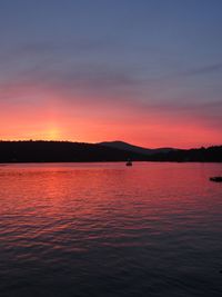 Scenic view of lake against romantic sky at sunset