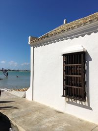 Built structure on beach against clear sky