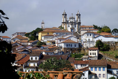 Church with townscape against sky