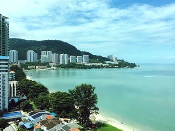 Scenic view of sea and buildings against sky