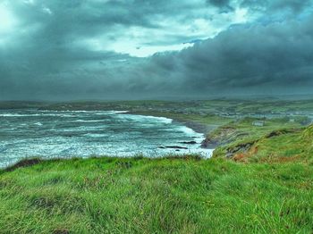 Scenic view of sea and green landscape