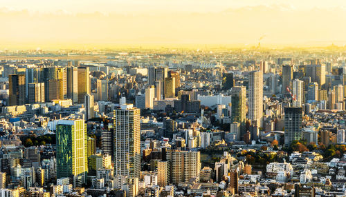 Aerial view of city buildings during sunset