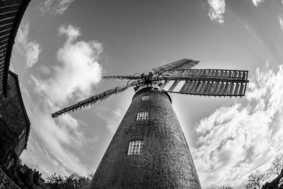 Low angle view of windmill against sky