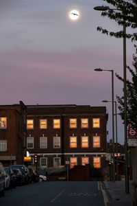 Illuminated building against sky at night