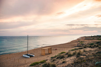 Scenic view of beach against sky during sunset