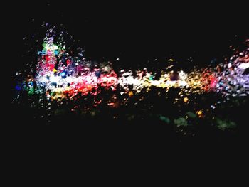 Full frame shot of colorful illuminated lights against sky at night