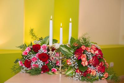 Close-up of bouquet and candles on centerpiece