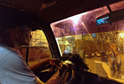 Portrait of woman seen through car window