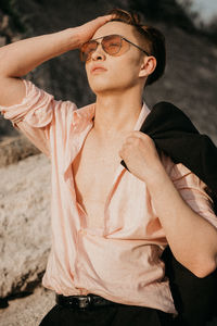 Midsection of man with arms raised