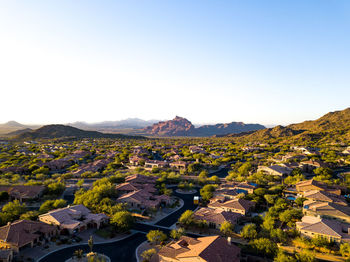 Panoramic view of buildings and mountains against clear sky