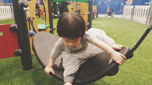 Rear view of boy playing in park