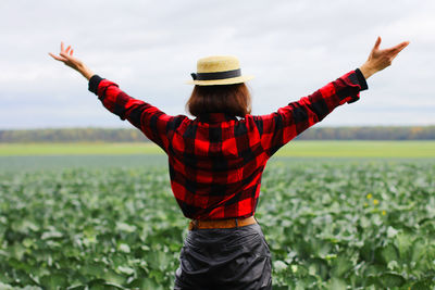 A girl walks through a cabbage field. gardening on an organic vegetable farm.