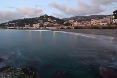 Scenic view of sea and buildings against sky