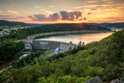 Scenic view of river against sky during sunset