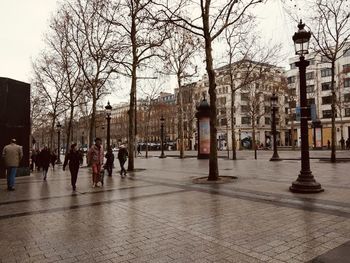 Group of people walking on street in city