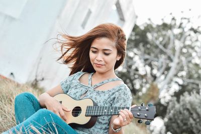 Young woman playing guitar