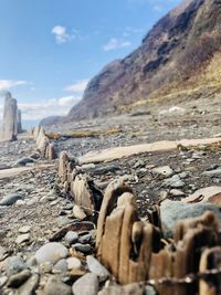 Surface level of stones on rocks against sky