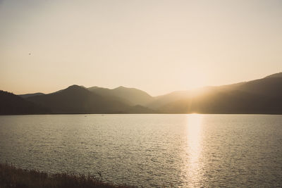 Scenic view of lake against sky during sunset