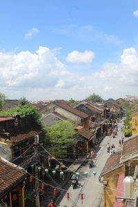 High angle view of people on road amidst buildings in city