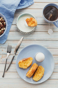 French fried toast with tea, boiled eggs and fresh yogurt. tasty farmer breakfast. flat lay