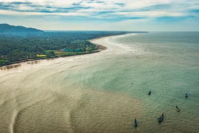 Beach isolated with fishing boats aerial shots with dramatic sky