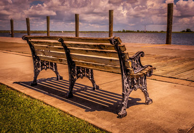 View of empty deck chairs against calm sea