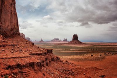 Scenic view of monument valley against cloudy sky