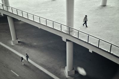 High angle view of people walking on footbridge