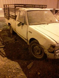 Old rusty car on road