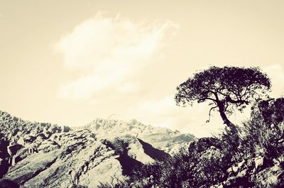 Scenic view of mountains against cloudy sky