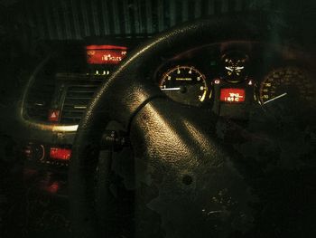 Close-up of illuminated car on windshield at night