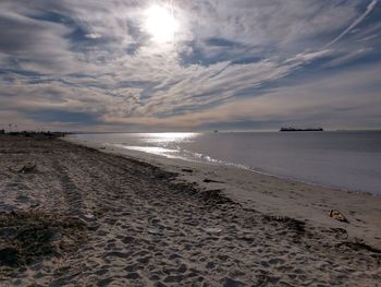 Scenic view of beach against sky during sunset